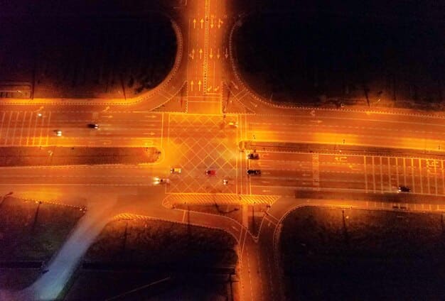 A futuristic looking image showing a driverless AI truck navigating a complex highway system, with data overlays indicating real-time traffic conditions and optimized routing suggestions.