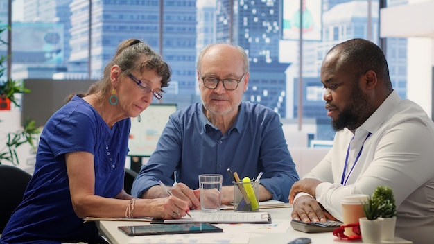 A diverse team of data scientists collaborating around a table, discussing ethical considerations and best practices for developing fair AI systems. The scene conveys a sense of teamwork, inclusivity, and responsible AI development.